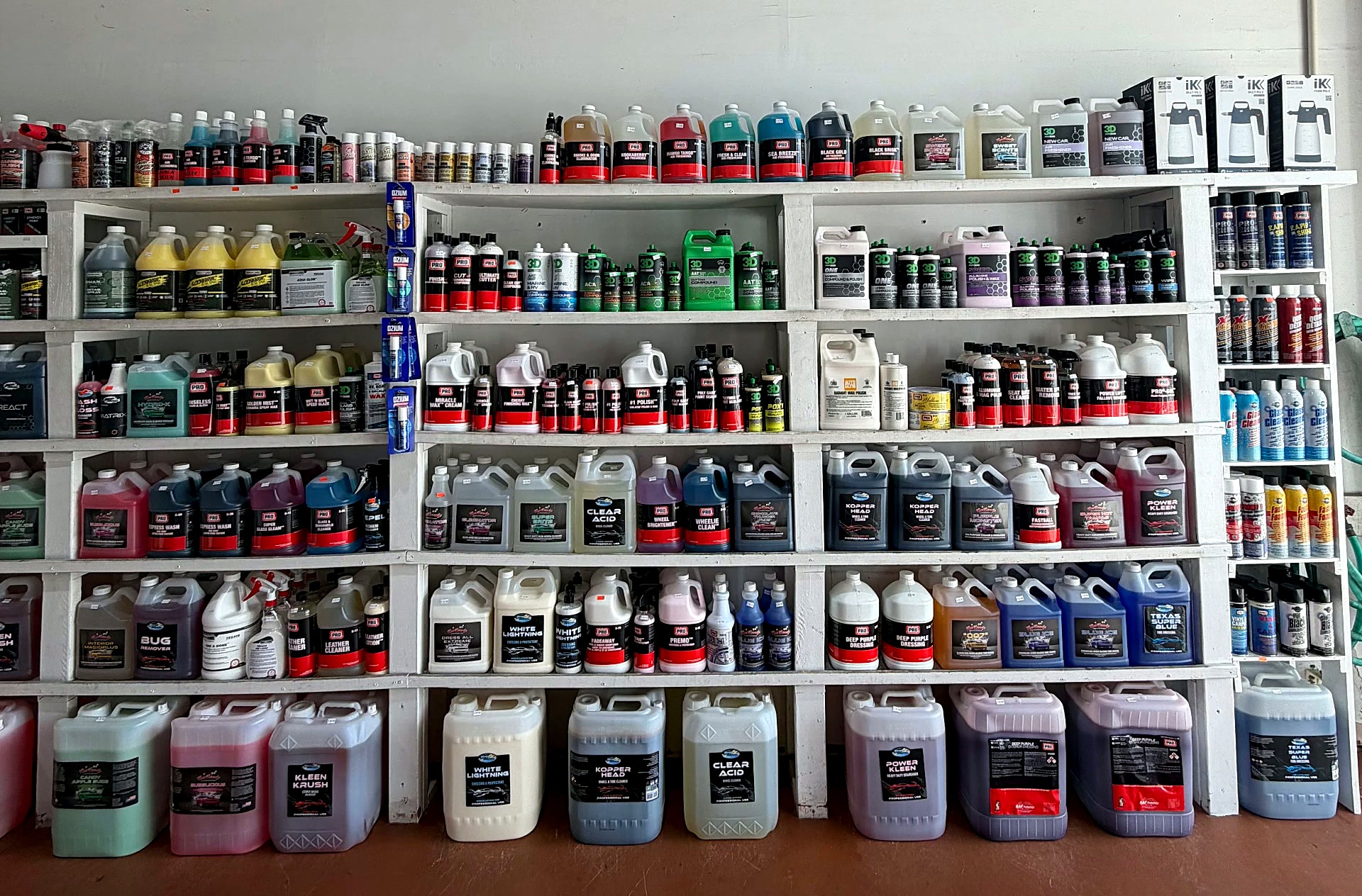 Shelves of detailing chemicals inside Expert Detail Supply in Oakland Park